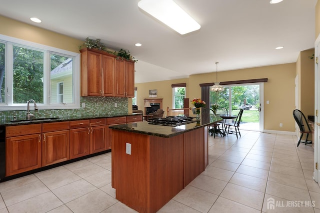 3 Wheatsheaf Ct, Plainsboro, NJ 08536 - kitchen with gas stovetop, brown cabinetry, light tile patterned floors, a center island, and recessed lighting