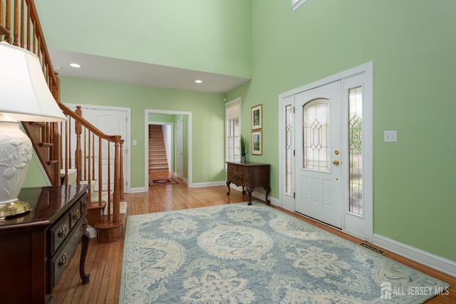 3 Wheatsheaf Ct, Plainsboro, NJ 08536 - foyer entrance with stairs, plenty of natural light, wood finished floors, a towering ceiling, and recessed lighting