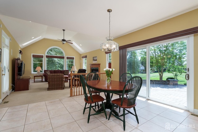 3 Wheatsheaf Ct, Plainsboro, NJ 08536 - dining space featuring light tile patterned flooring, a ceiling fan, a chandelier, vaulted ceiling, and a fireplace