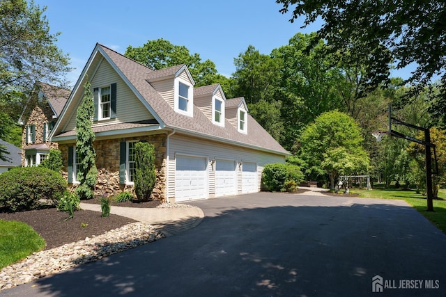 3 Wheatsheaf Ct, Plainsboro, NJ 08536 - view of front of home with stone siding, a garage, asphalt driveway, and roof with shingles