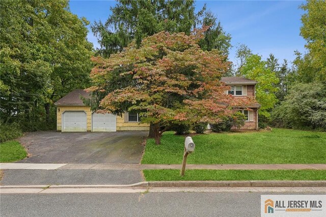 view of front of property with a front yard and a garage