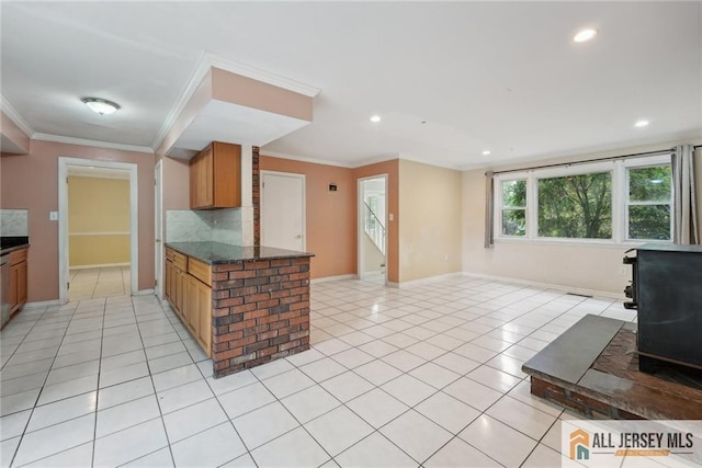 kitchen with ornamental molding, open floor plan, backsplash, and light tile patterned flooring