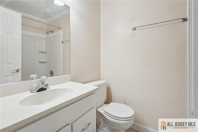 bathroom with vanity, crown molding, a shower, and toilet