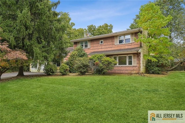 view of front of house with a chimney and a front yard