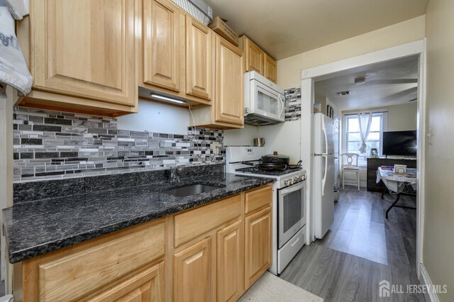 109 Washington St, Perth Amboy, NJ 08861 - kitchen featuring white appliances, light wood finished floors, a sink, and decorative backsplash