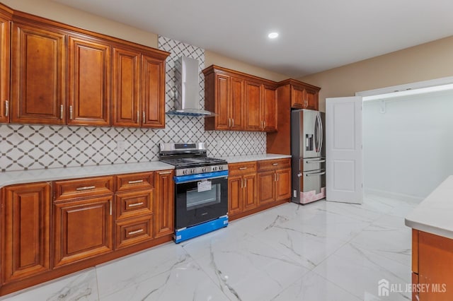 kitchen with marble finish floor, wall chimney exhaust hood, appliances with stainless steel finishes, and light countertops