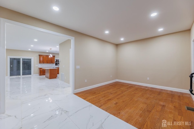 unfurnished room with recessed lighting, visible vents, and baseboards