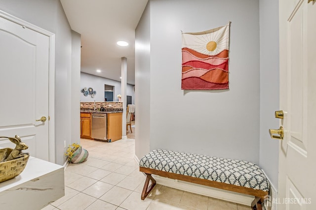 hall featuring light tile patterned floors