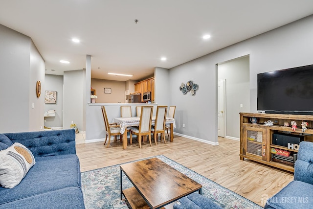 living room with light hardwood / wood-style flooring