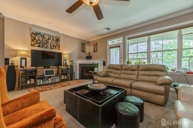 326 Sloan Ct, Matawan, NJ 07747 - carpeted living room with a ceiling fan, crown molding, healthy amount of natural light, and a glass covered fireplace