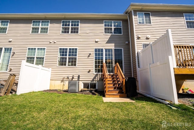 4 Woodrose Ln, Monroe, NJ 08831 - back of house with a lawn, central AC unit, and fence