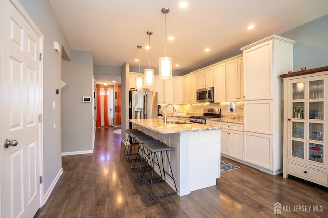 4 Woodrose Ln, Monroe, NJ 08831 - kitchen featuring stainless steel appliances, dark wood-style floors, a sink, backsplash, and light stone counters