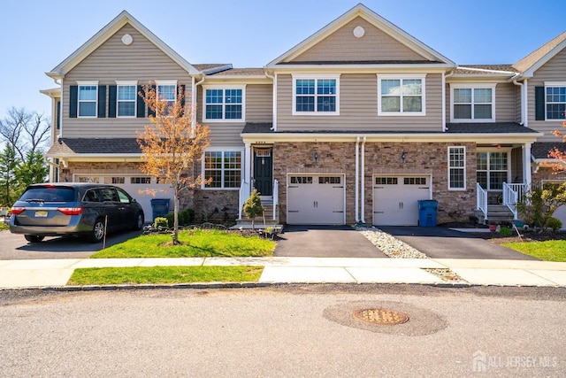 4 Woodrose Ln, Monroe, NJ 08831 - townhome / multi-family property featuring an attached garage, driveway, and stone siding