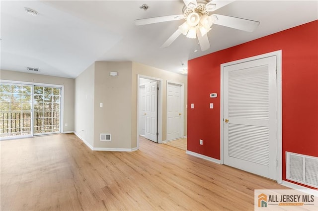 spare room featuring light wood-style flooring and visible vents