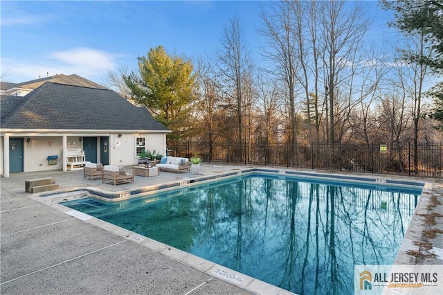 pool featuring a patio area, fence, and an outdoor living space