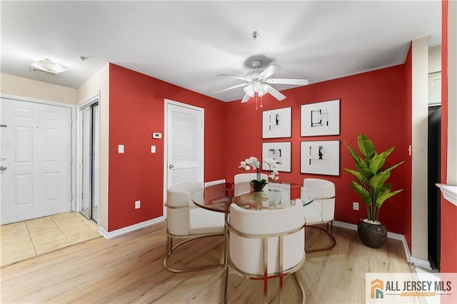 dining area with light wood-style flooring, baseboards, and ceiling fan