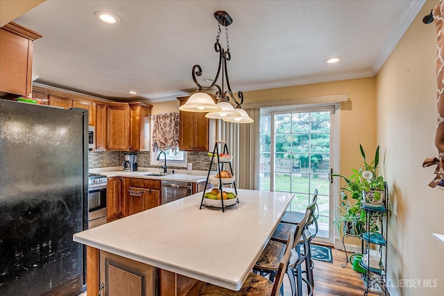 6 Dundar Rd, Edison, NJ 08817 - kitchen with appliances with stainless steel finishes, brown cabinets, light countertops, ornamental molding, and backsplash