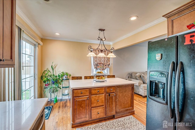 6 Dundar Rd, Edison, NJ 08817 - kitchen with black fridge, light wood-style flooring, ornamental molding, light countertops, and brown cabinets