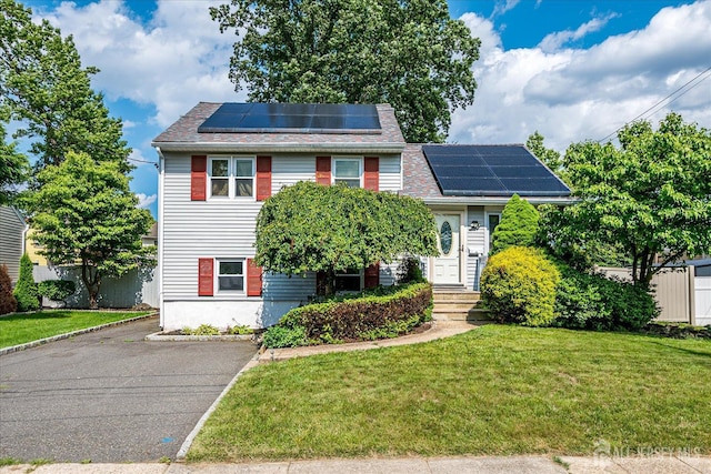 6 Dundar Rd, Edison, NJ 08817 - view of front of home with roof mounted solar panels, a front lawn, and driveway