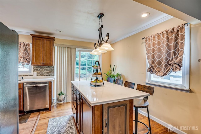6 Dundar Rd, Edison, NJ 08817 - kitchen with dishwasher, brown cabinets, light countertops, a breakfast bar, and ornamental molding
