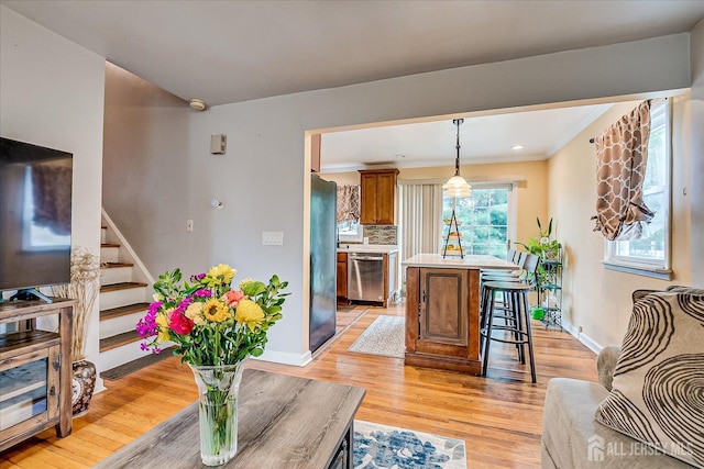 6 Dundar Rd, Edison, NJ 08817 - living room with light wood-style floors, stairs, and crown molding
