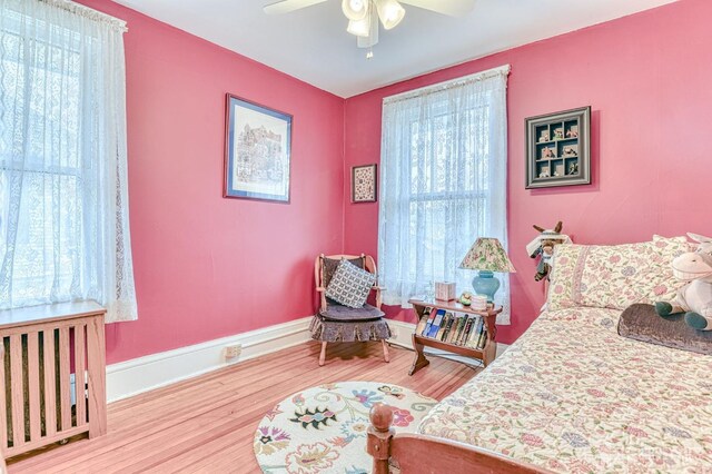 bedroom featuring wood finished floors, ceiling fan, and baseboards