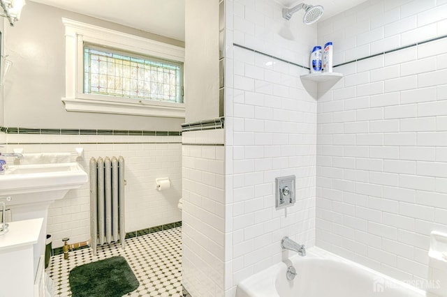 5 Llewellyn Pl, New Brunswick, NJ 08901 - bathroom featuring radiator heating unit, tub / shower combination, wainscoting, tile walls, and tile patterned floors