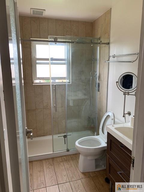 47 Judson St Unit 14B, Edison, NJ 08837 - bathroom featuring a stall shower, vanity, and wood finished floors
