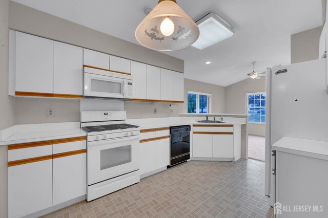 kitchen featuring white cabinets, pendant lighting, white appliances, and sink