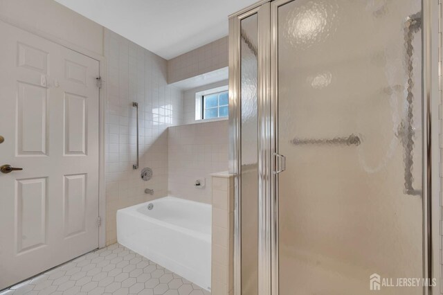 bathroom featuring tile patterned floors and shower with separate bathtub