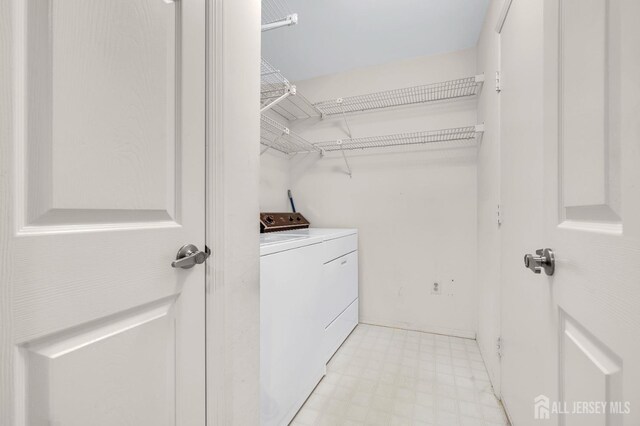 clothes washing area featuring independent washer and dryer