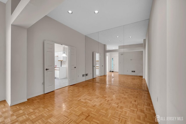 unfurnished room with light parquet flooring