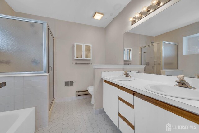 full bathroom featuring vanity, tile patterned floors, separate shower and tub, toilet, and baseboard heating