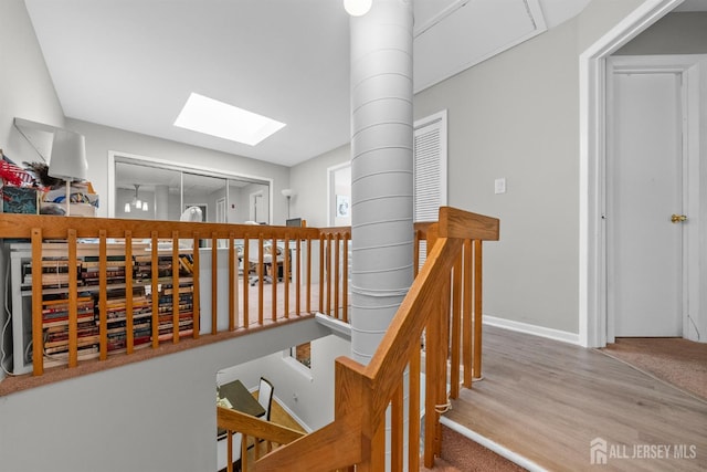 1058 Schmidt Ln, North Brunswick, NJ 08902 - staircase featuring a skylight, wood finished floors, and baseboards