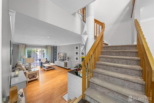 1058 Schmidt Ln, North Brunswick, NJ 08902 - staircase featuring wood finished floors and crown molding