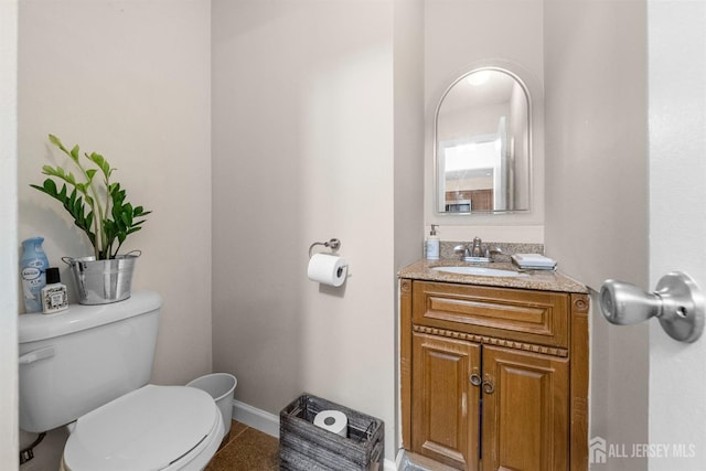 1058 Schmidt Ln, North Brunswick, NJ 08902 - bathroom with toilet, baseboards, and vanity