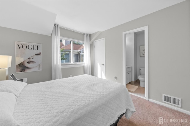 1058 Schmidt Ln, North Brunswick, NJ 08902 - carpeted bedroom with ensuite bath and baseboards