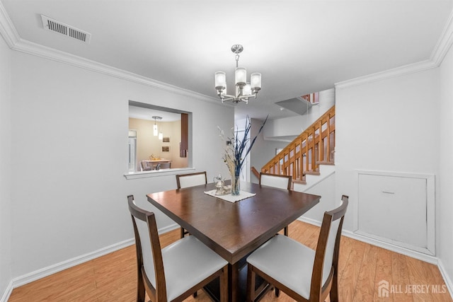 1058 Schmidt Ln, North Brunswick, NJ 08902 - dining space with a chandelier, light wood-style floors, ornamental molding, and baseboards