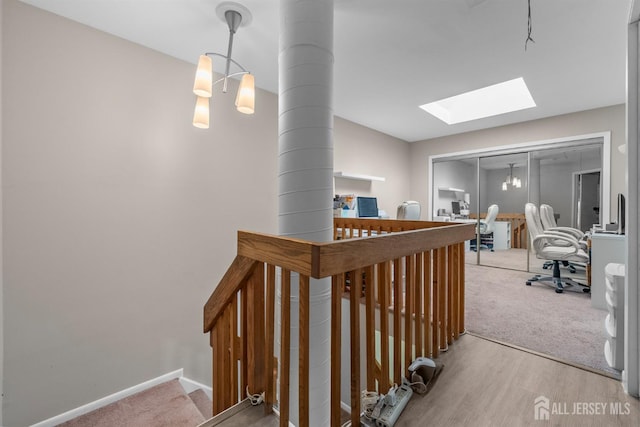 1058 Schmidt Ln, North Brunswick, NJ 08902 - corridor with a desk, a skylight, and wood finished floors