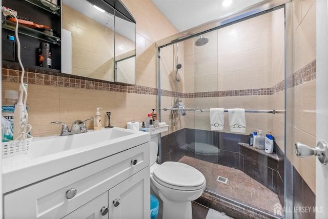 1058 Schmidt Ln, North Brunswick, NJ 08902 - bathroom featuring toilet, a shower stall, vanity, backsplash, and tile walls