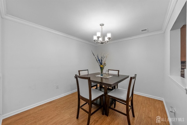 1058 Schmidt Ln, North Brunswick, NJ 08902 - dining room with a chandelier, light wood-type flooring, ornamental molding, and baseboards