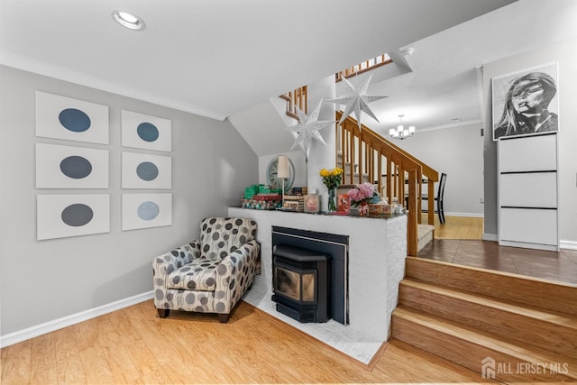 1058 Schmidt Ln, North Brunswick, NJ 08902 - living area featuring stairs, a wood stove, crown molding, baseboards, and a chandelier