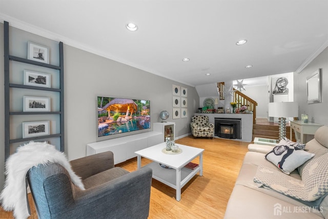 1058 Schmidt Ln, North Brunswick, NJ 08902 - living room with crown molding, light wood finished floors, recessed lighting, and a lit fireplace