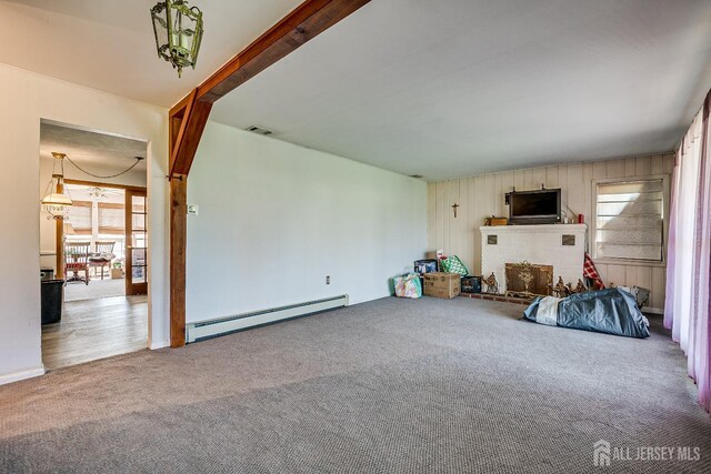 80 Gates Rd, Franklin Twsp, NJ 08873 - unfurnished living room with wooden walls, visible vents, a baseboard heating unit, and carpet floors