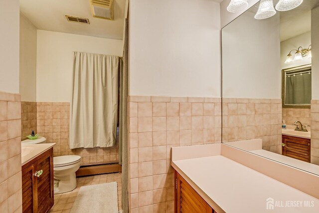 80 Gates Rd, Franklin Twsp, NJ 08873 - bathroom with tile walls, visible vents, wainscoting, and vanity