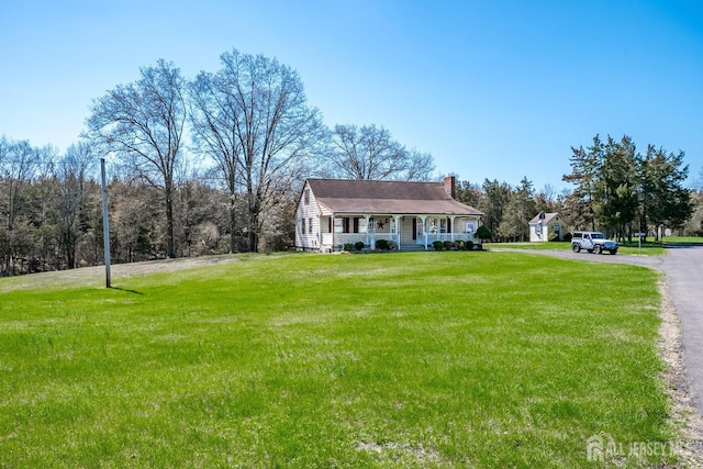 80 Gates Rd, Franklin Twsp, NJ 08873 - view of front of property featuring aphalt driveway, a front yard, a chimney, and a porch