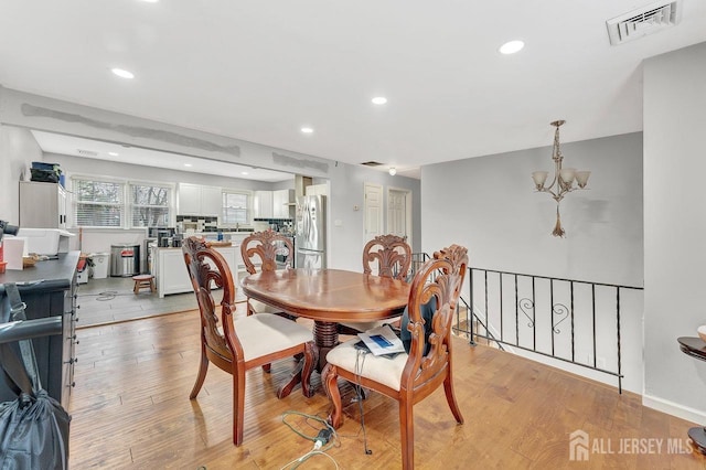 dining area featuring recessed lighting, an inviting chandelier, visible vents, and light wood-style floors