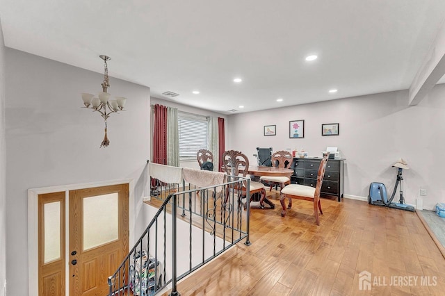 interior space featuring a notable chandelier, light wood finished floors, recessed lighting, visible vents, and baseboards