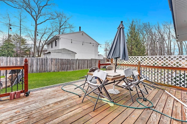 wooden deck with a yard and fence