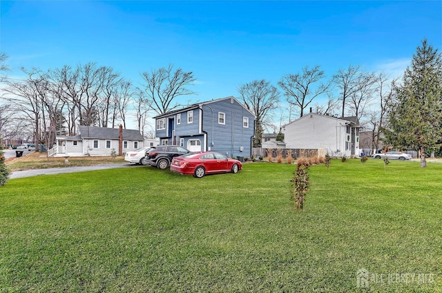 exterior space featuring driveway and a front yard